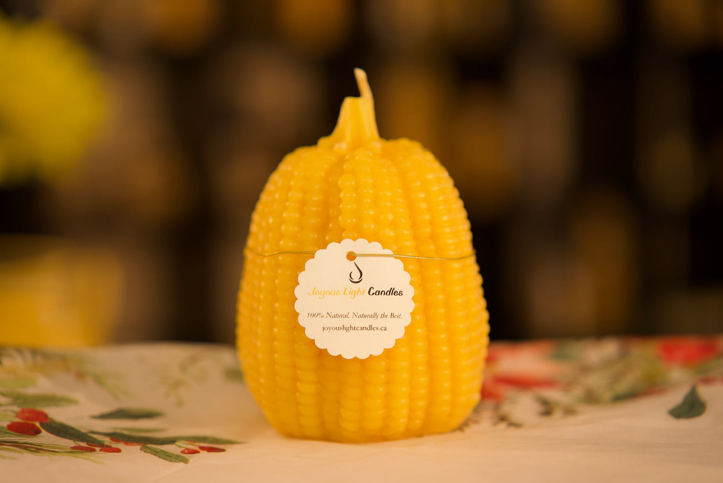 Tall harvest-inspired pure beeswax candle with decorative corn and pumpkin relief, 3.25x5 inches