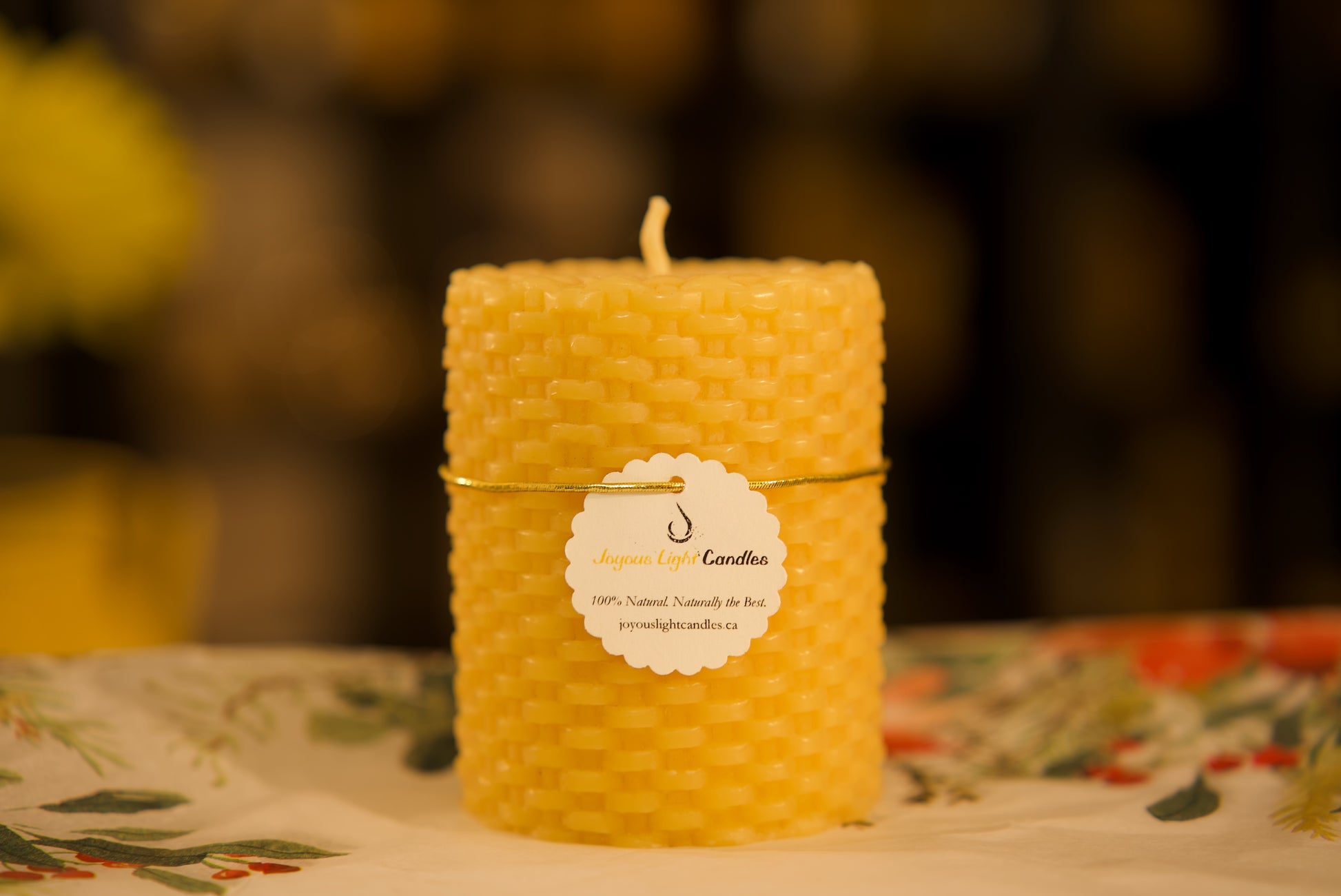 Textured pure beeswax pillar with intricate basket weave pattern, artisanal decor, 3x3.75 inches